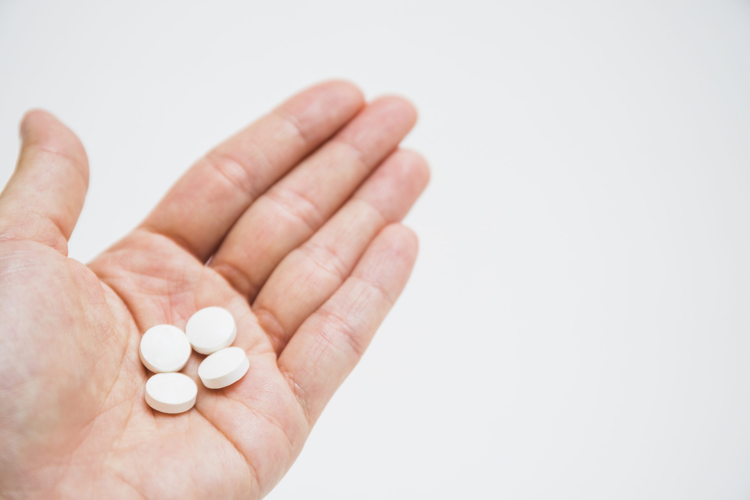 round white pills on hand specialty orals manufacturing